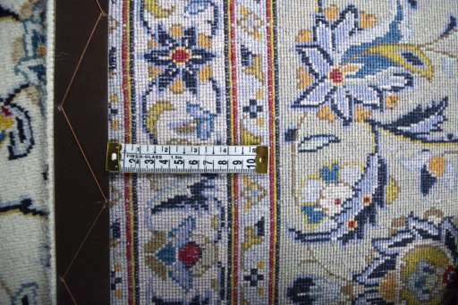 Backside of handmade 2000s Kashan rug showing knot structure and weave density