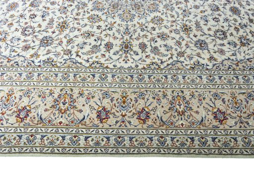 Corner detail of 2000s Kashan rug showing border pattern and Wool pile