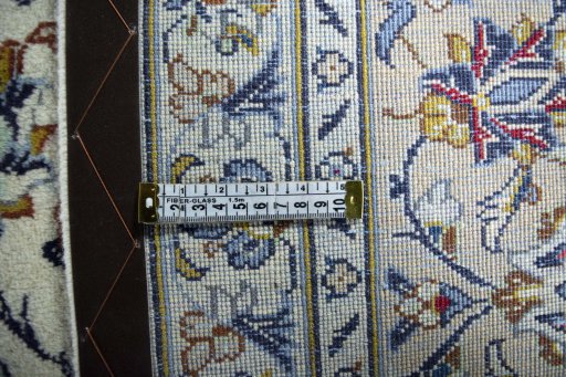 Backside of handmade 2000s Kashan rug showing knot structure and weave density