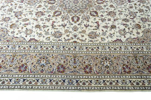 Corner detail of 2000s Kashan rug showing border pattern and Wool pile
