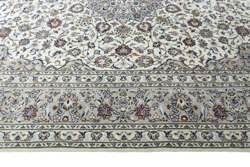 Corner detail of 2000s Kashan rug showing border pattern and Wool pile