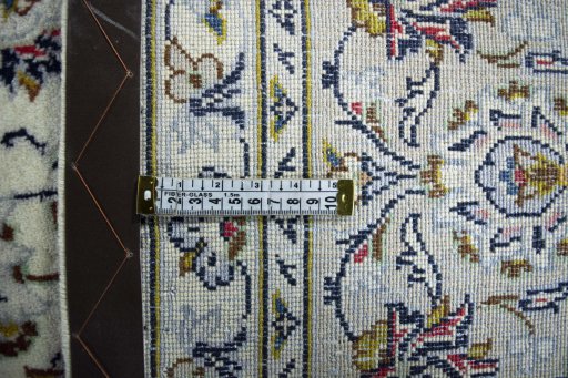 Backside of handmade 2000s Kashan rug showing knot structure and weave density
