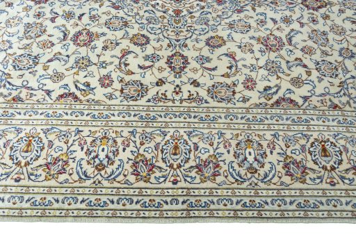 Corner detail of 2000s Kashan rug showing border pattern and Wool pile