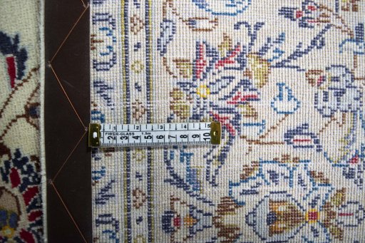 Backside of handmade 2000s Kashan rug showing knot structure and weave density