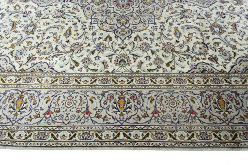 Corner detail of 2000s Kashan rug showing border pattern and Wool pile