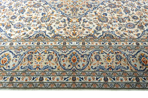 Corner detail of 2000s Kashan rug showing border pattern and Wool pile