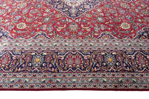 Corner detail of 2000s Kashan rug showing border pattern and Wool pile