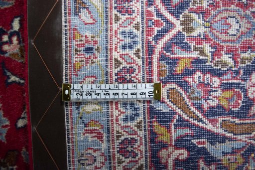 Backside of handmade 2000s Kashan rug showing knot structure and weave density