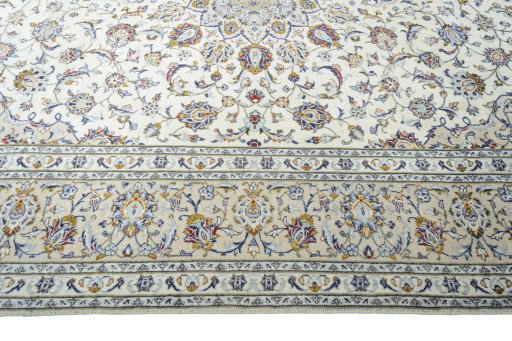 Corner detail of 2000s Kashan rug showing border pattern and Wool pile