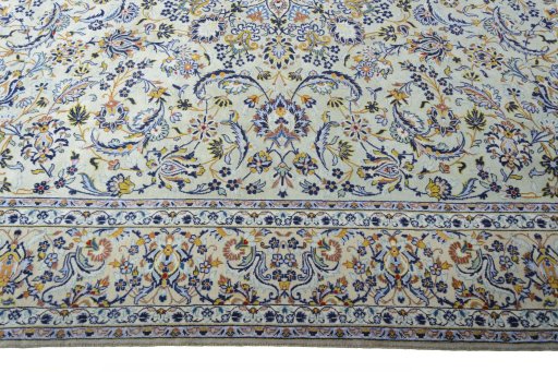 Corner detail of 2000s Kashan rug showing border pattern and Wool pile