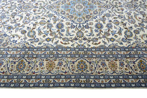 Corner detail of 2000s Kashan rug showing border pattern and Wool pile