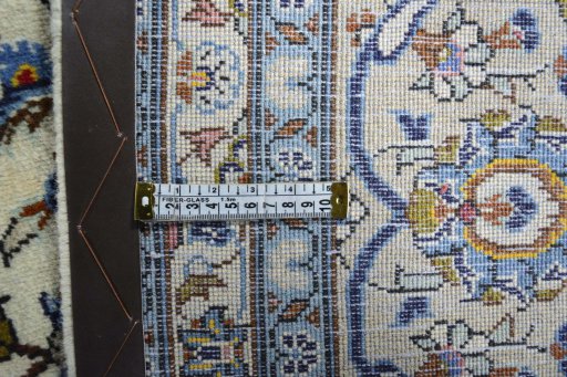 Backside of handmade 2000s Kashan rug showing knot structure and weave density