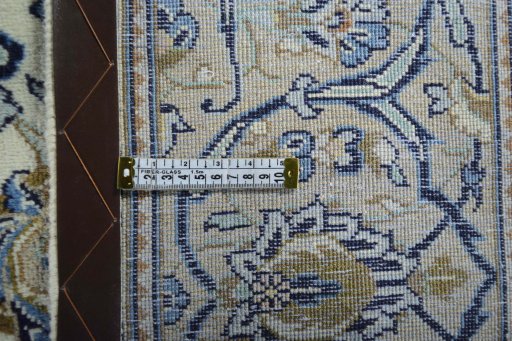 Backside of handmade 2000s Kashan rug showing knot structure and weave density