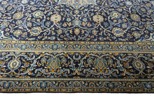 Corner detail of 2000s Kashan rug showing border pattern and Wool pile