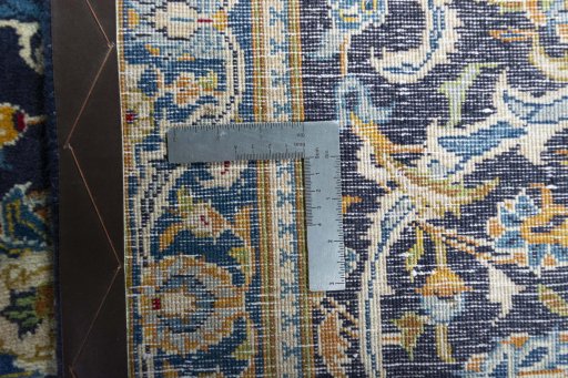 Backside of handmade 2000s Kashan rug showing knot structure and weave density