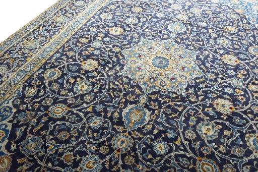 Backside of handmade 2000s Kashan rug showing knot structure and weave density