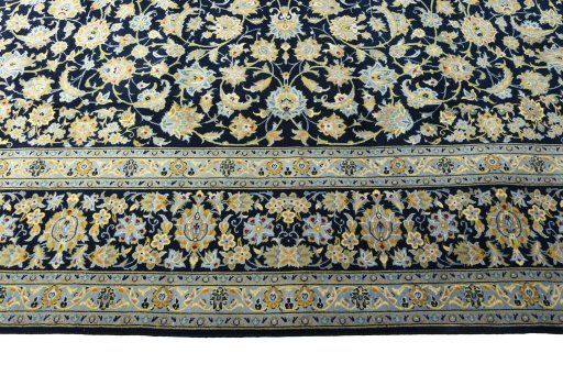 Corner detail of 2000s Kashan rug showing border pattern and Wool pile