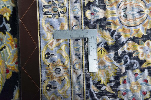 Backside of handmade 2000s Kashan rug showing knot structure and weave density