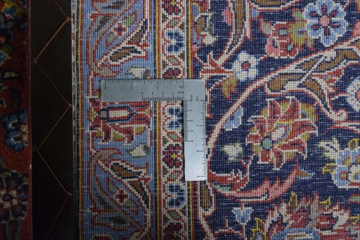 Backside of handmade New Kashan rug showing knot structure and weave density