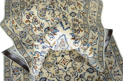 Corner detail of 2000s Kashan rug showing border pattern and Wool pile