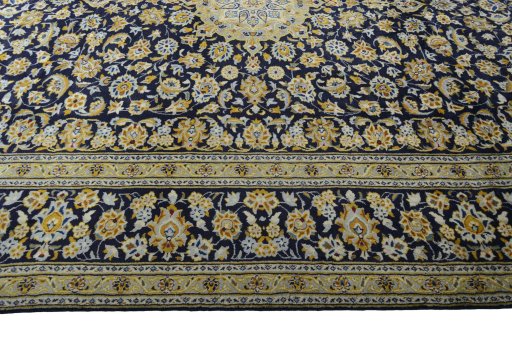 Corner detail of 2000s Kashan rug showing border pattern and Wool pile