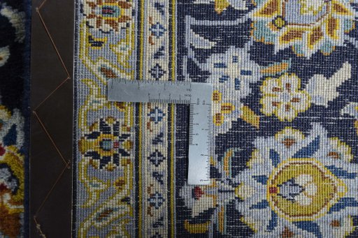 Backside of handmade 2000s Kashan rug showing knot structure and weave density