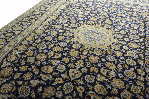 Backside of handmade 2000s Kashan rug showing knot structure and weave density