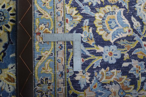 Backside of handmade 2000s Kashan rug showing knot structure and weave density