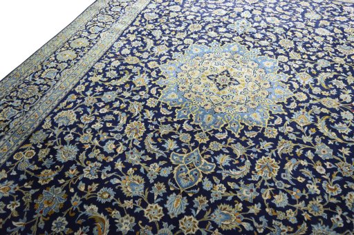 Backside of handmade 2000s Kashan rug showing knot structure and weave density