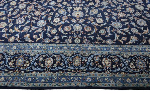 Corner detail of 2000s Kashan rug showing border pattern and Wool pile