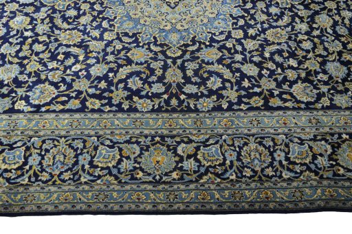 Corner detail of 2000s Kashan rug showing border pattern and Wool pile
