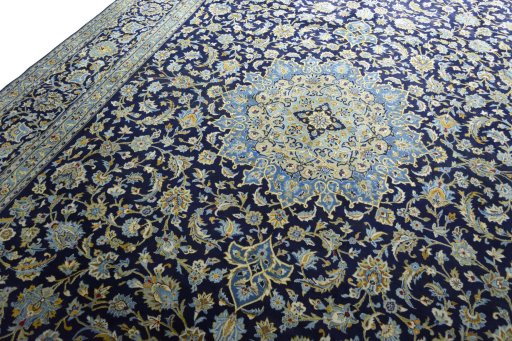 Backside of handmade 2000s Kashan rug showing knot structure and weave density