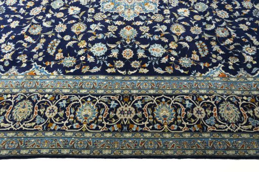 Corner detail of 2000s Kashan rug showing border pattern and Wool pile