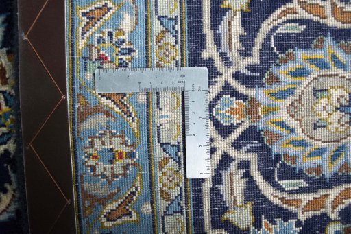 Backside of handmade 2000s Kashan rug showing knot structure and weave density
