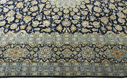 Corner detail of 2000s Kashan rug showing border pattern and Wool pile