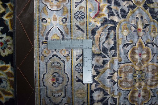 Backside of handmade 2000s Kashan rug showing knot structure and weave density
