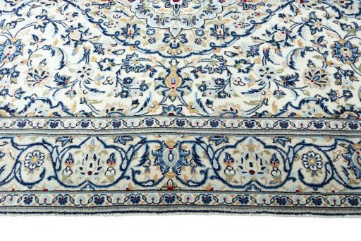 Corner detail of 2000s Kashan rug showing border pattern and Wool pile