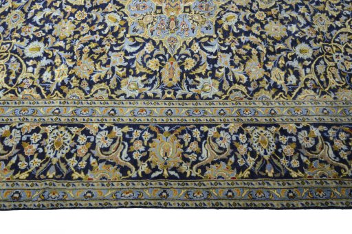 Corner detail of 2000s Kashan rug showing border pattern and Wool pile