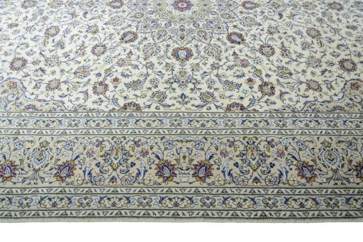 Corner detail of 2000s Kashan rug showing border pattern and Wool pile