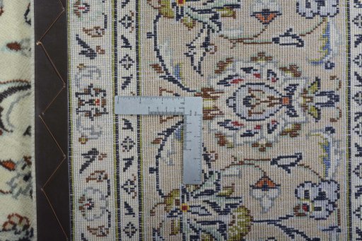 Backside of handmade 2000s Kashan rug showing knot structure and weave density