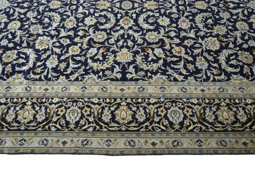 Corner detail of 2000s Kashan rug showing border pattern and Wool pile