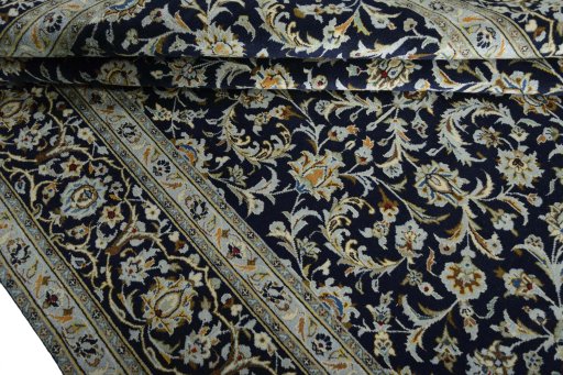 Close-up detail of 2000s Kashan rug from Iran / Persia showing Wool weave