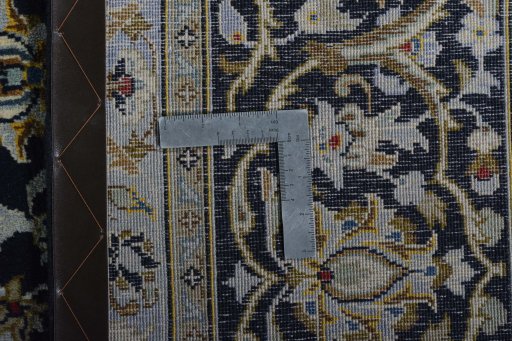 Backside of handmade 2000s Kashan rug showing knot structure and weave density