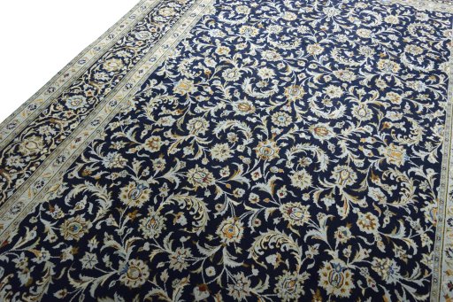 Backside of handmade 2000s Kashan rug showing knot structure and weave density