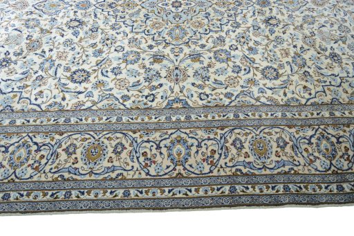 Corner detail of 2000s Kashan rug showing border pattern and Wool pile