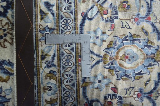 Backside of handmade 2000s Kashan rug showing knot structure and weave density