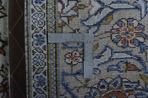 Backside of handmade 2000s Kashan rug showing knot structure and weave density