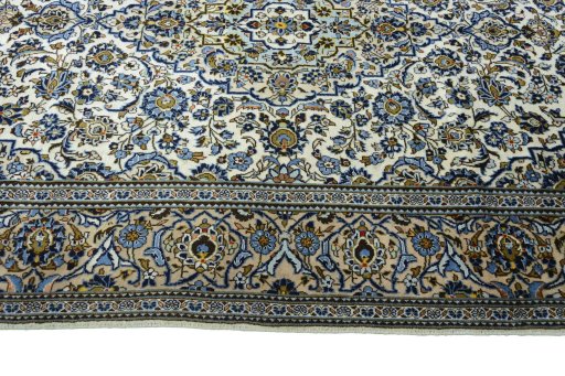 Corner detail of 2000s Kashan rug showing border pattern and Wool pile