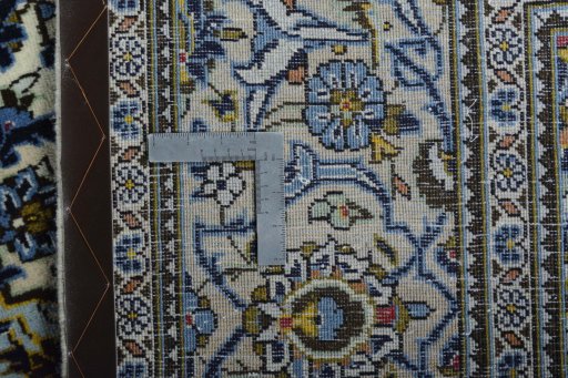Backside of handmade 2000s Kashan rug showing knot structure and weave density
