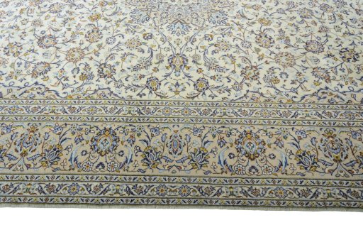 Corner detail of 2000s Kashan rug showing border pattern and Wool pile